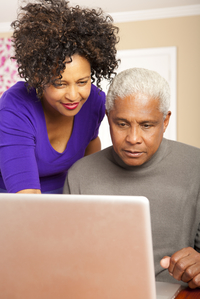 man and womam looking at computer