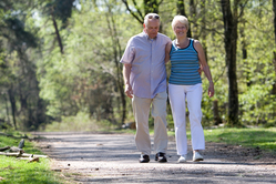 man and woman walking down a country road