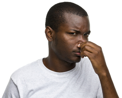 African-American man holding his nose