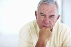 man with hand under chin