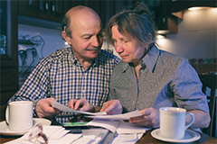 older couple looking at forms