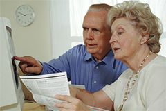 older couple looking at a computer screen