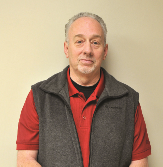 Charles Kerr standing in front of wall