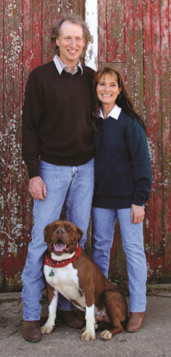 Dawn Rittmeyer standing with husband in front of barn