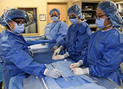 Former nurse practitioner (NP) residents refresh skills while working with surgical instruments in an operating room training environment at the New Mexico VA Healthcare System.