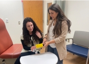 Sylvia Lombardo, PharmD, right, discusses medication in an exam room at the Altoona VA.  As a pharmacist with VA, Lombardo can not only connect with Veterans to help them achieve their health goals but can also impact the future of Veteran health care by assisting trainees in their residency.