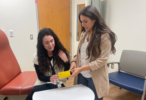 Sylvia Lombardo, PharmD, right, discusses medication in an exam room at the Altoona VA.  As a pharmacist with VA, Lombardo can not only connect with Veterans to help them achieve their health goals but can also impact the future of Veteran health care by assisting trainees in their residency.  