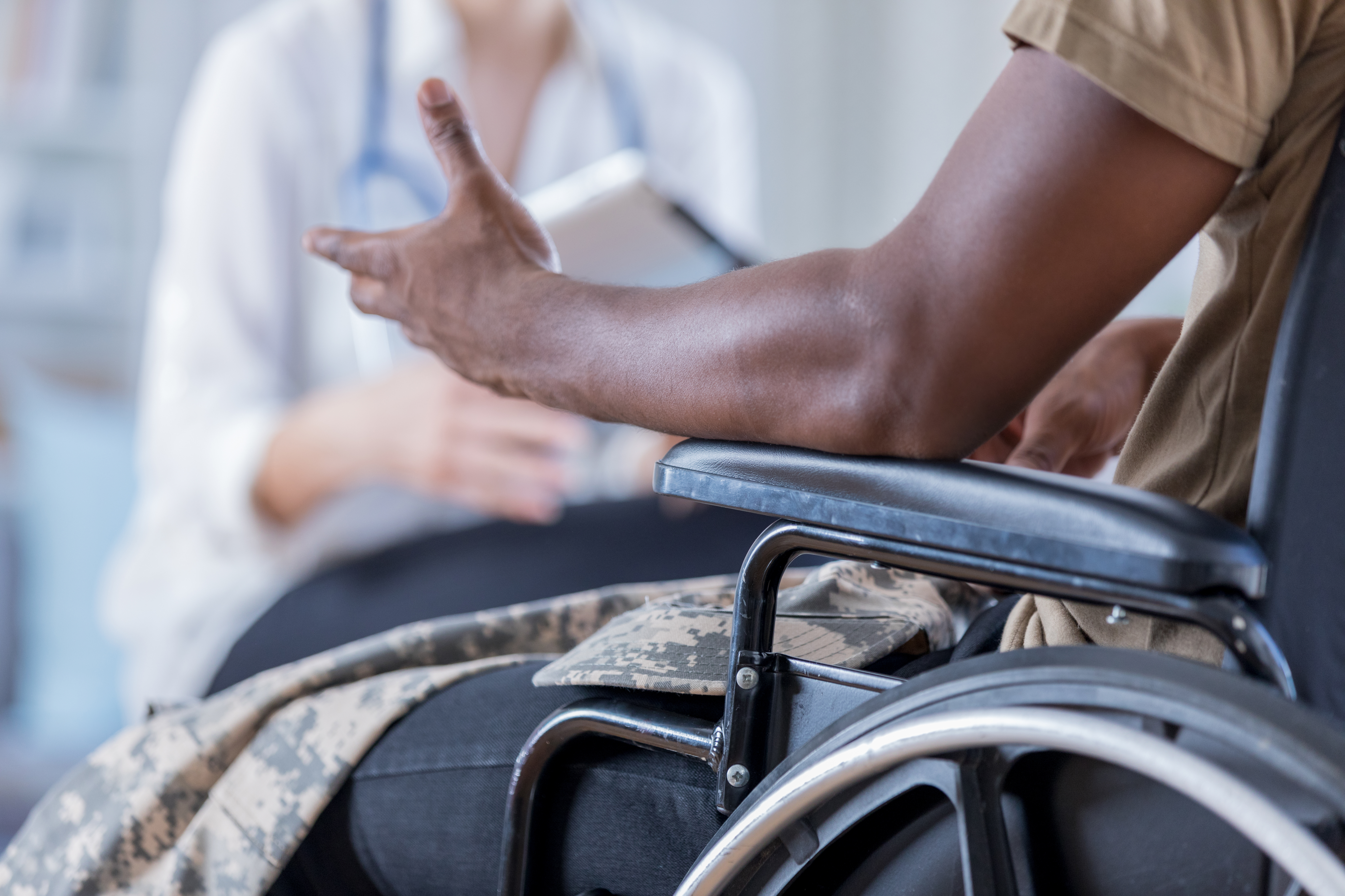 Veteran in wheelchair consulting with doctor