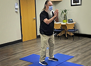 older man wear mask practicing tai chi