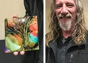 man holding a piece of art his painting