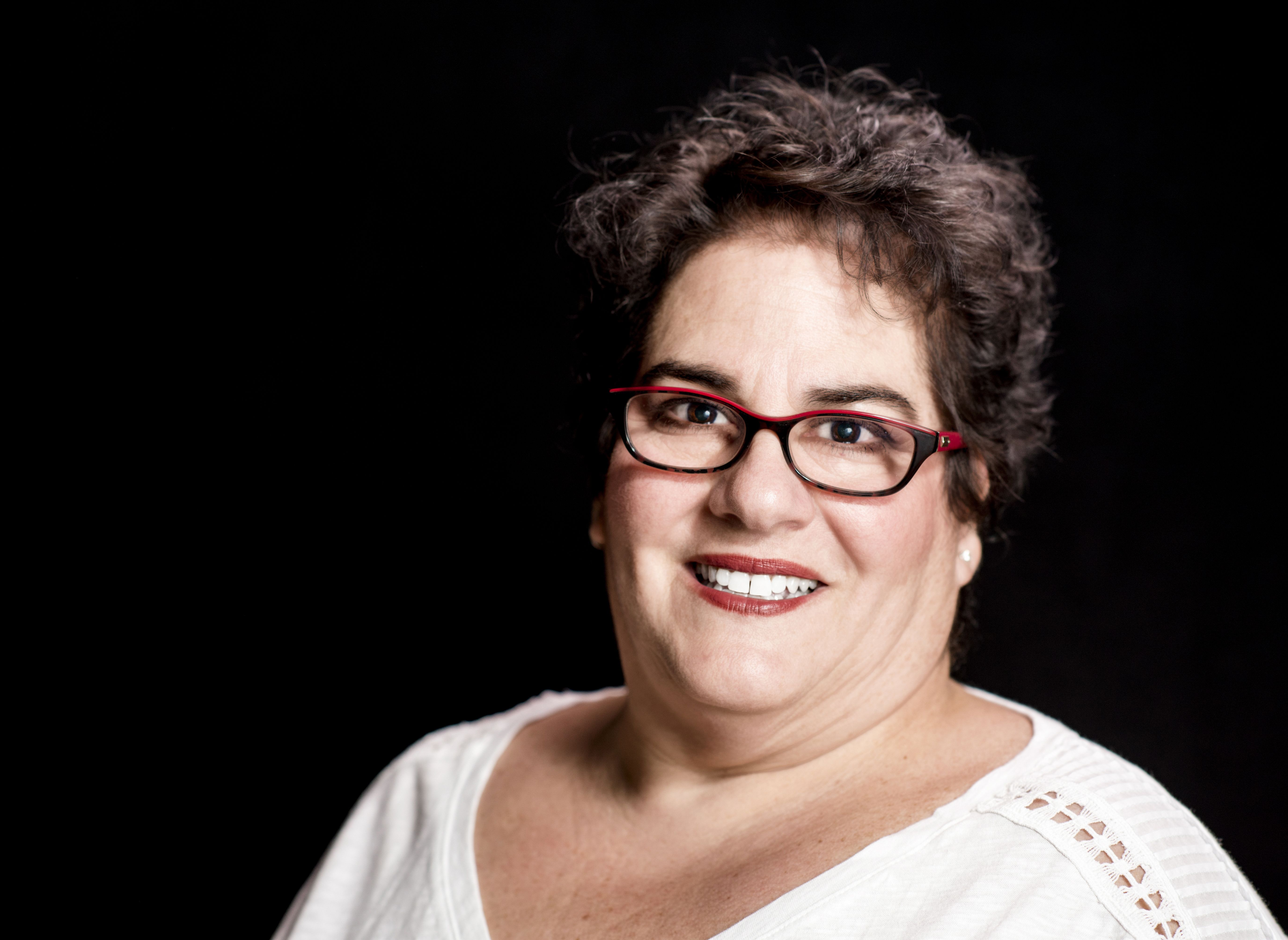 Heavier Set Middle-Aged Woman wearing Glasses in Studio