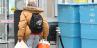 veteran walking through faility holding bags