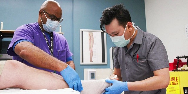 Photo of two doctors with patient